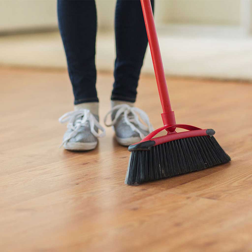 Lady cleaning hardwood floor | Towne Flooring Center